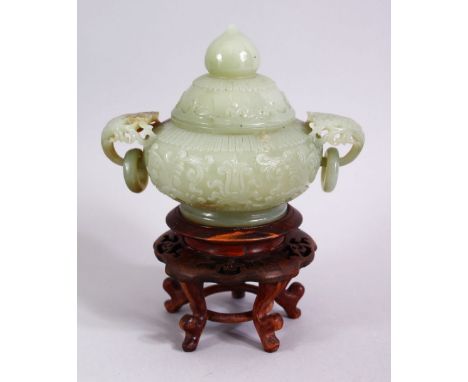 A CHINESE CARVED CELADON JADE TWIN HANDLE CENSER &amp; HARDWOOD STAND, the censer carved with floral handles and rings, with 