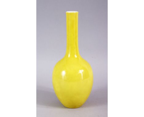 A CHINESE YELLOW GROUND MONOCHROME PORCELAIN BOTTLE VASE, the base with a six character mark, 22cm.