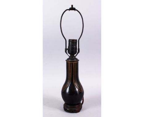 AN AFRICAN CARVED WOODEN LAMP VASE, the inner shaking like a maraca, 40cm high.