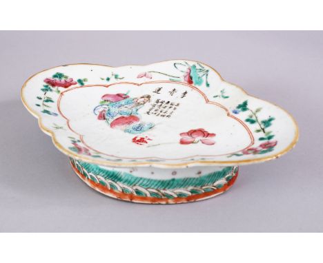 A CHINESE 19TH CENTURY FAMILLE ROSE PORCELAIN FOOTED DISH, depicting a seated figure amongst flora with calligraphy, with a w