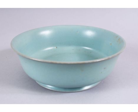 A CHINESE CELADON RU WARE POTTERY CALLIGRAPHIC BOWL, the base of the bowl with gilded incised calligraphy, 17.5cm diameter .