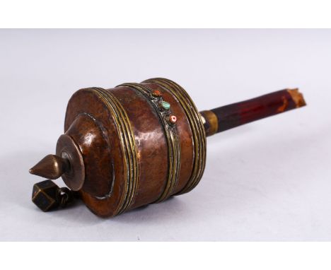 A 19TH CENTURY TIBETAN  PRAYER WHEEL - containing a manuscript, with inlaid semi precious stones, 27cm