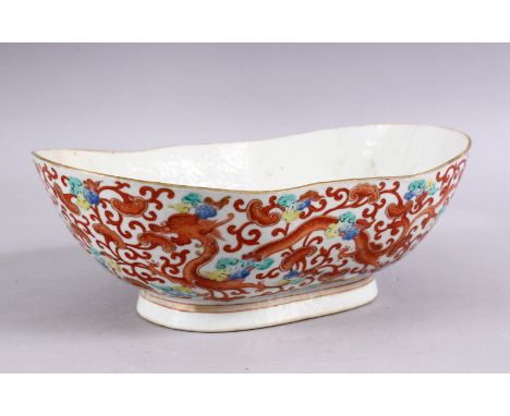 A 19TH CENTURY CHINESE IRON RED PORCELAIN DRAGON BOWL, the body decorated with scenes of dragons and phoenix birds amongst fo