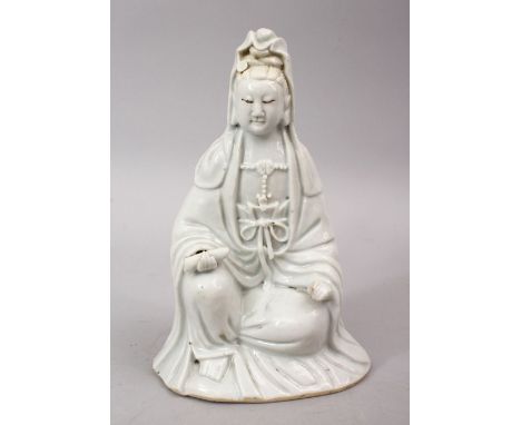 A 19TH CENTURY CHINESE BLANC DE CHINE PORCELAIN FIGURE OF GUANYIN, in a seated position holding a scroll, 19cm high.