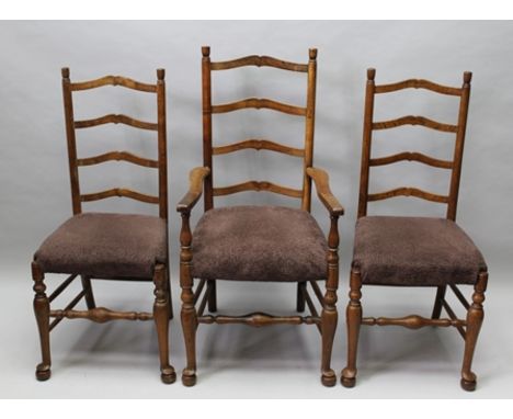 A SET OF SIX ARTS AND CRAFTS STYLE FOUR RUNG LADDER BACK CHAIRS with later upholstered seat pads, having turned forelegs with