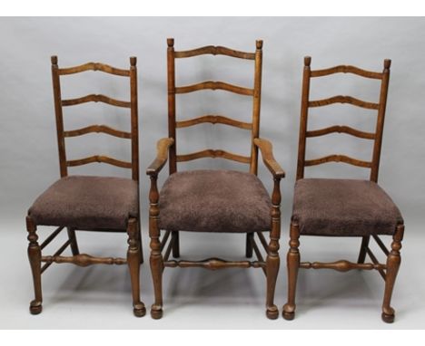 A SET OF SIX ARTS AND CRAFTS STYLE FOUR RUNG LADDER BACK CHAIRS with later upholstered seat pads, having turned forelegs with