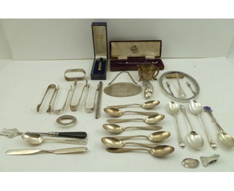 A COLLECTION OF MISCELLANEOUS SILVER ITEMS includes, spoons, sugar tongs, pickle fork, a parrot head handle from a parasol et