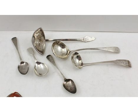 A WHITE METAL SUGAR SIFTER of unusual form with seated cat terminal, together with two Edinburgh sauce ladles, a Victorian ca
