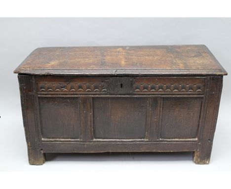A PART 18TH CENTURY PLANK FORMED OAK BOX CHEST with plain lift-up lid, carved frieze, over tri-panel front, 52cm x 100cm wide
