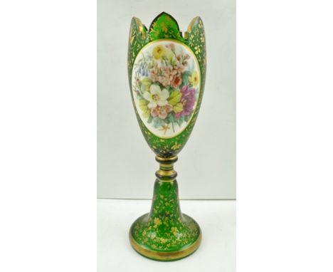 A LATE 19TH CENTURY BOHEMIAN GREEN GLASS VASE, castellated rim, all over gilded decoration with floral hand painted oval pane