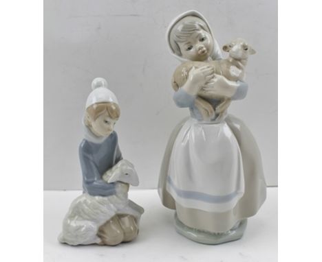 A LLADRO FIGURE OF A YOUNG BOY kneeling, cradling a sheep, with printed marks to base, 14.5cm high, together with a FIGURE OF