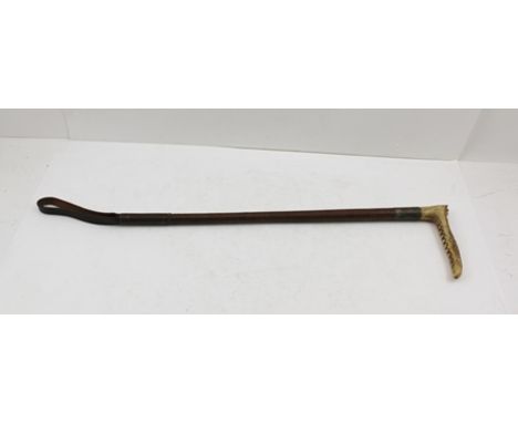 A LADY'S HUNTING WHIP with horn grip, plated collar and plaited leather shaft 