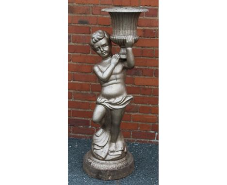 A CAST METAL STATUETTE OF A YOUNG BOY holding aloft a pedestal planter, 134cm high 