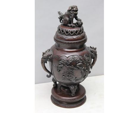 A LATE 19TH CENTURY JAPANESE KORO ON STAND having well cast dog of fo finial, on pierced lid, the bulbous body cast in three 