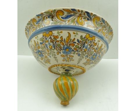 A CONTINENTAL MAJOLICA HANGING PLANTER, floral painted decoration in pale blue, green and ochre, 26cm diameter, with fitted s