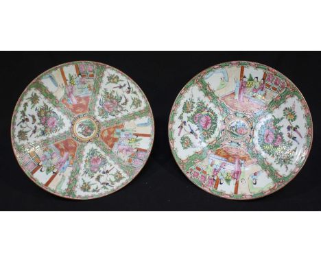 A pair of early 20th century Chinese canton porcelain plates, decorated with Poly-Chrome enamels depicting scenes of daily li