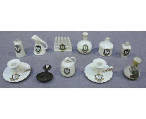 A small collection of Dunstable crested china, including a row of five bullets, a sack bottle, pouring jug and a metal caddy 