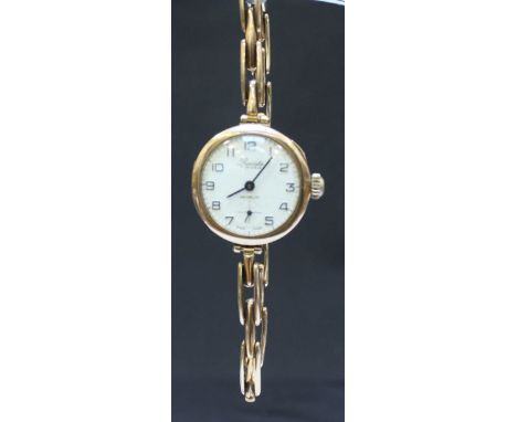A Precista ladies 9ct gold wristwatch on gold expanding strap, the gold back stamped Rolex, dial white enamel with Arabic num