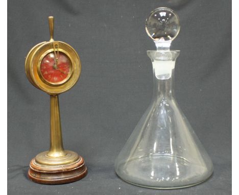 A 1920's novelty brass 'ships telegraph' clock, the red guilloche enamel dial with white Arabic numerals, mounted on turned w