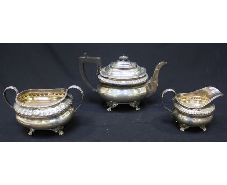 A three-piece Victorian silver tea set, of compressed oblong form with gadrooned rims and raised on lion's paw feet, comprisi