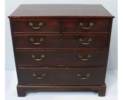 An early 19th Century mahogany chest of two short over three long graduated drawers, with oak and walnut linings, original br