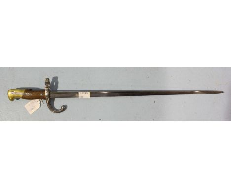 A 1876 pattern French sword bayonet, with 52cm blade, wooden handle with brass pommel, numbered and stamped with armory marks