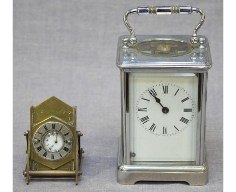 A Victorian Gothic revival brass pocket watch easel stand, containing silver watch, 7cm, together with a chrome carriage cloc