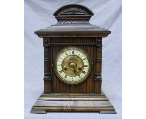 An Edwardian walnut mantle clock by H.A.C Wurtemburg, the brass and enamel dial with Roman Numerals, 45cm high