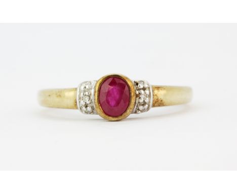 A 9ct yellow gold ring set with an oval cut ruby and diamonds, (N).