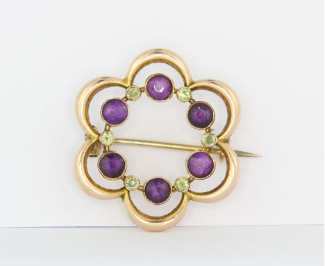 An early 20th century Murrle Bennet 9ct yellow gold Suffragette brooch set with amethyst and peridot, Dia. 2.5cm.