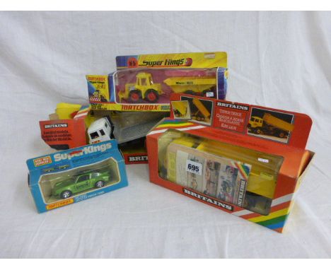 Four boxed vehicles including Britains 9583 Tipper Truck & 9582 Flatbed Transporter (no window to box) and Matchbox Super Kin