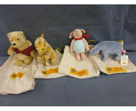 Four Steiff Winnie the Pooh character soft toys all in original Steiff bags including Pooh Bear, Piglet, Tigger and Eyeore