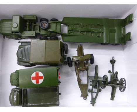 Seven vintage military vehicles and artillery including Dinky and Britains in good condition