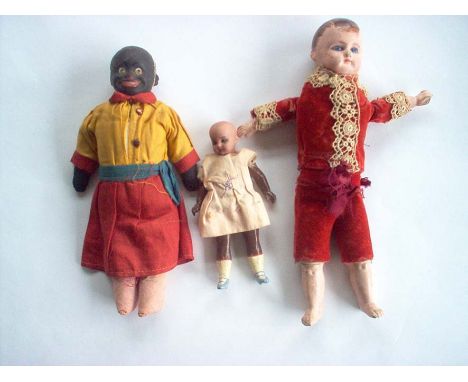 Three Early 20th century Dolls including Small Bisque Headed Doll, Composition Headed Boy Doll with Blue Eyes and a Black Pap