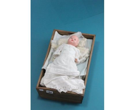 Crib with bedding and a German bisque headed doll marked Germany 363 to neck