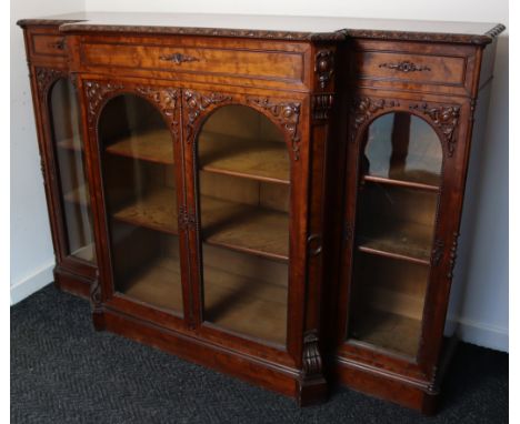 A 19th century FRENCH FRUITWOOD BREAK-FRONT CABINET, possibly pearwood, fitted one long &amp; two short drawers above adjusta