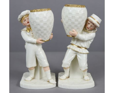 A pair of Royal Worcester porcelain “Kate Greenaway” type standing figures of children, ivory &amp; gilt, the faces &amp; han