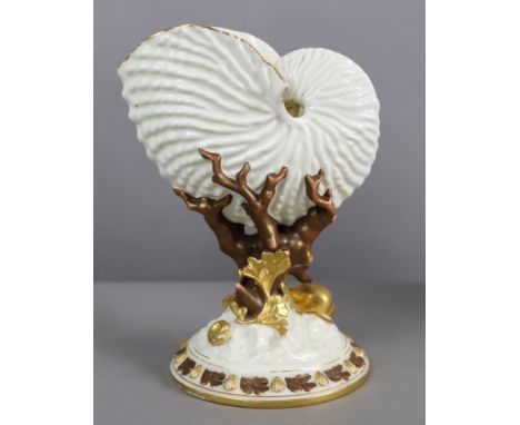 A Royal Worcester porcelain nautilus vase of ivory ground, on coral &amp; seaweed support &amp; circular base highlighted in 