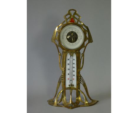 An early 20th century Art Nouveau brass &amp; enamelled desk barometer, with 3½” paper dial, inset white enamel mercury therm