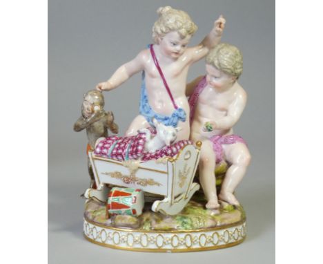 A Meissen porcelain figure group after Schönheit of ‘Two putti playing with a cradle and a monkey examining a goat’, on oval 