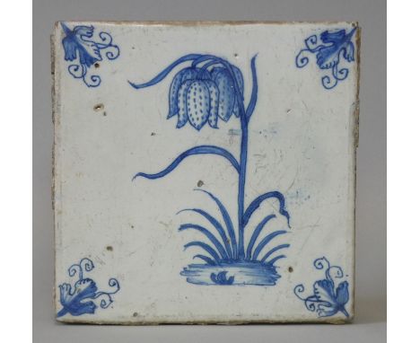 A 17th century Dutch delft blue &amp; white flower tile painted with a snake’s head fritillary; 5¼” square.