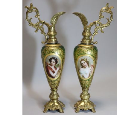 A PAIR OF 19th century BOHEMIAN GREEN GLASS SLENDER OVOID EWERS with gilt-decorated wide borders, each with white-overlaid ov