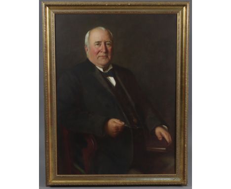 ENGLISH SCHOOL, late 19th/early 20th century.  A half-length portrait of a gentleman, seated, wearing black jacket, holding s