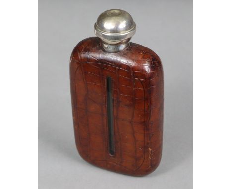 A George V NOVELTY SILVER-MOUNT GLASS SPIRIT FLASK, covered in tan crocodile skin case, the silver ball-shaped screw-cap conc