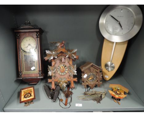 A selection of wall mounted clocks including 31 Day and Black Forrest style cuckoo clock