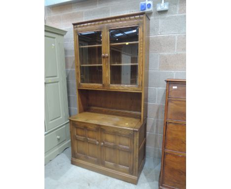 A modern Ercol wall unit, dark to mid stain
