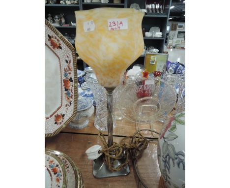 An art deco table lamp with chrome base and orange and cream mottled glass shade