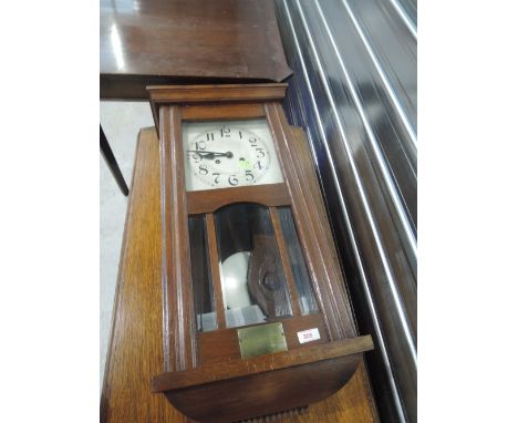 An early 20th Century oak cased wall clock