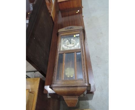 An early 20th Century oak cased wall clock