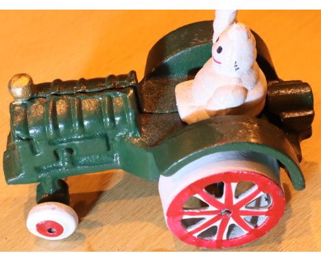Cast iron Michelin Man in tractor, L: 11 cm. P&amp;P Group 2 (£18+VAT for the first lot and £3+VAT for subsequent lots) 